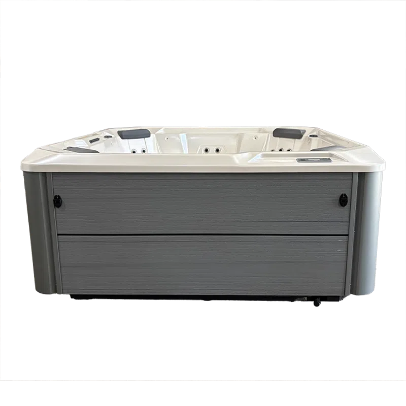 Modern rectangular hot tub with gray exterior panels and white interior seating and jets.