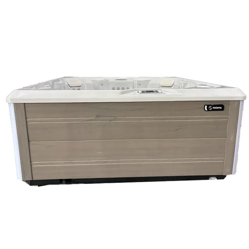 Modern rectangular hot tub with light wood panel exterior and white smooth top edges, featuring built-in headrests.