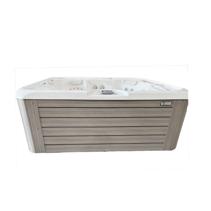 Modern outdoor hot tub with wood-textured panels and white interior featuring multiple jets for relaxation