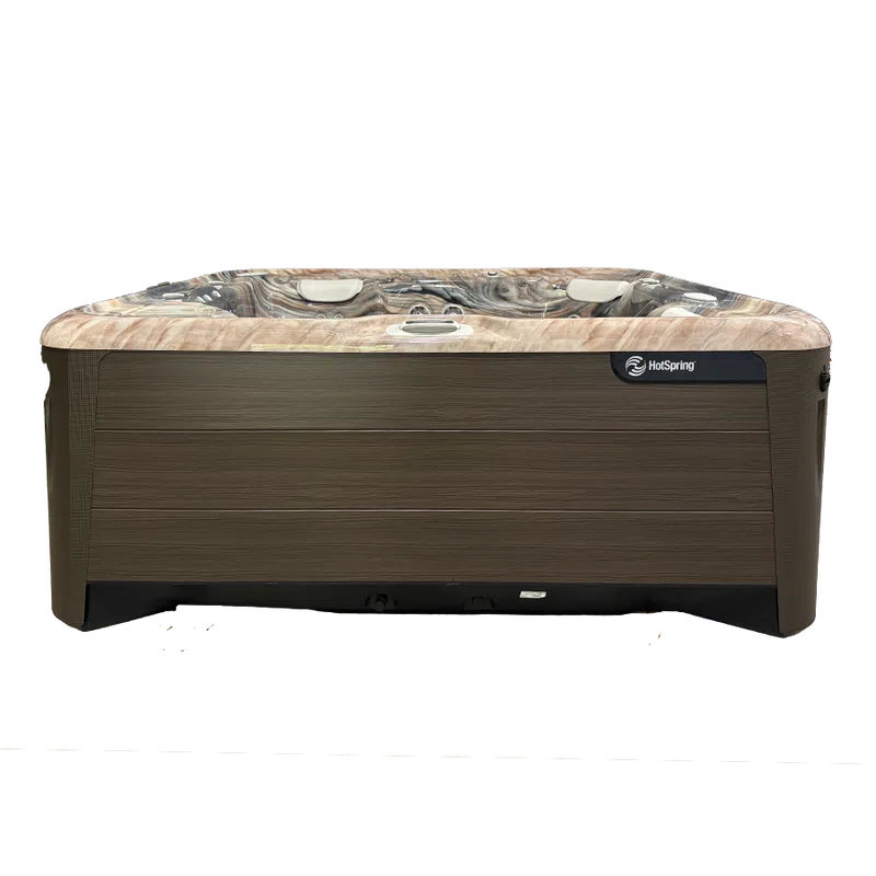 Modern HotSpring hot tub with wood panel exterior and marble-patterned interior seating with headrests.