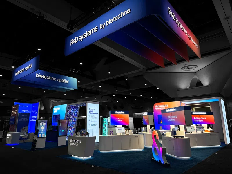 Custom trade show exhibit with a reception counter set back from the aisle