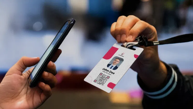 Exhibitor scanning an attendee badge with a handheld lead capture device at a trade show
