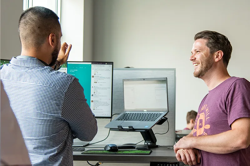 Two coworkers talking and laughing