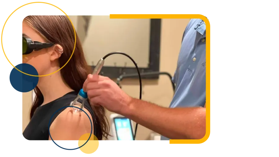 Chiropractor performs spinal adjustment on patient lying face down on treatment table in clinic.