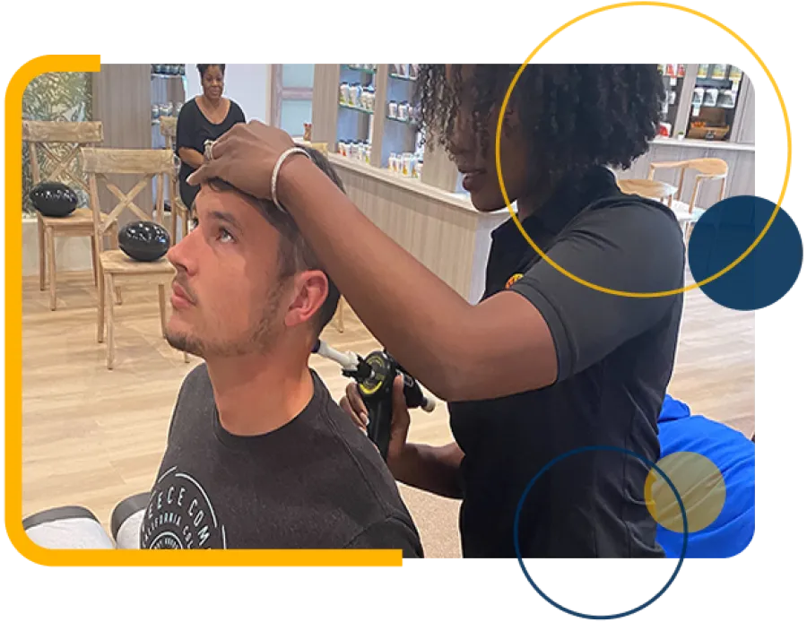 Healthcare professional examining man's ear with an otoscope in a modern clinic setting.
