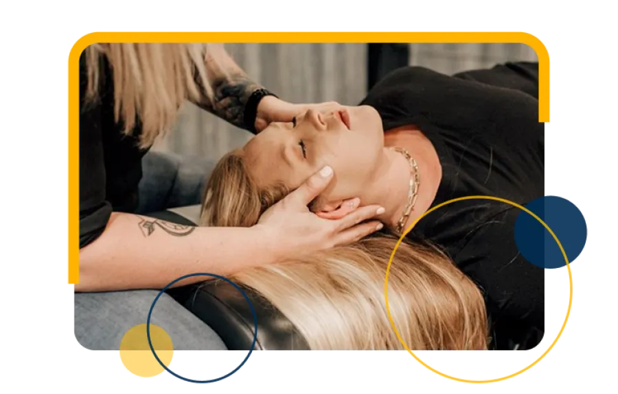 Chiropractor performing spinal adjustment on a patient lying face down on a treatment table in a clinic.