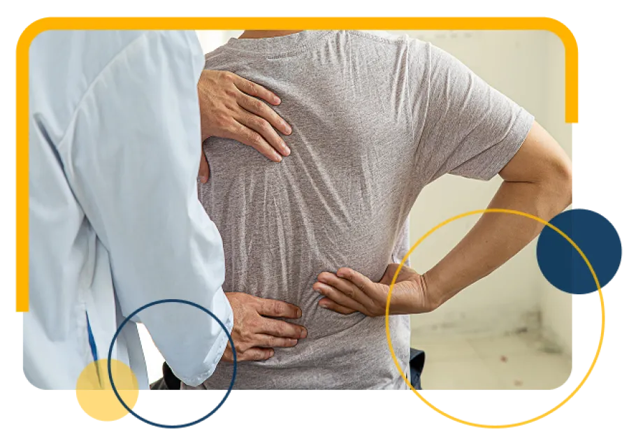Doctor examining a patient experiencing lower back pain in a clinical setting.