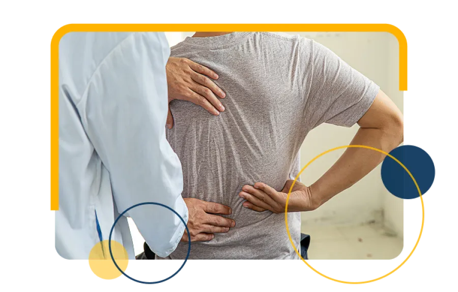 Doctor examining a male patient with back pain, focusing on lower spine and back discomfort assessment.