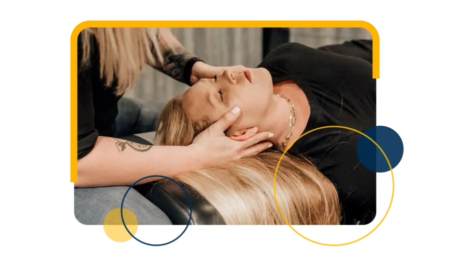 Chiropractor performs spinal adjustment on patient lying face down on treatment table in clinic.