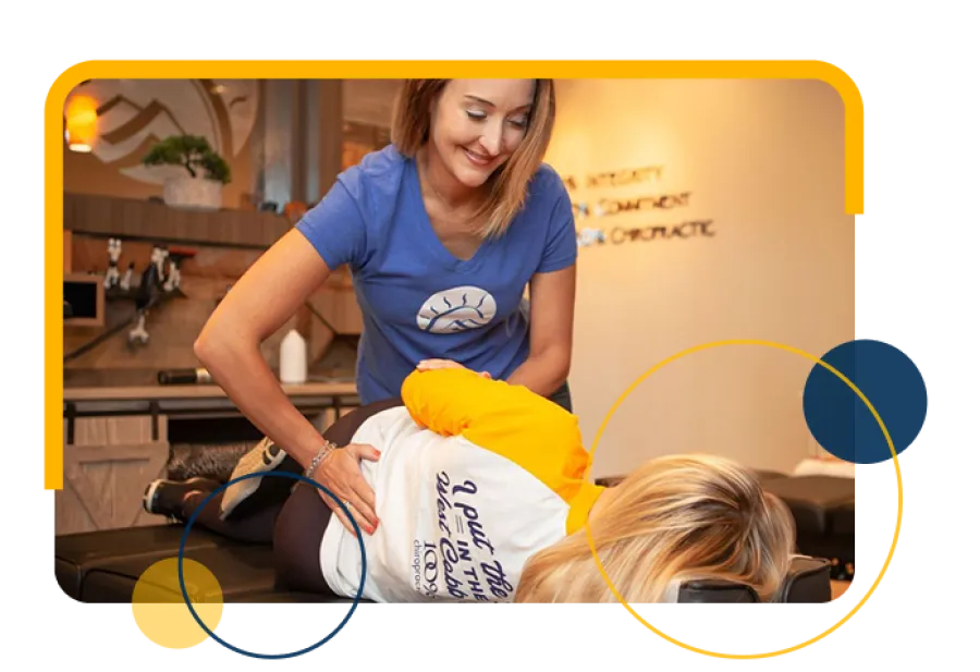 Chiropractor adjusting patient's lower back in a wellness clinic with warm, calming decor and professional care.