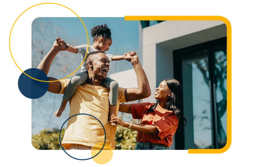 Happy family with father carrying daughter on shoulders and smiling mother outdoors by modern home.