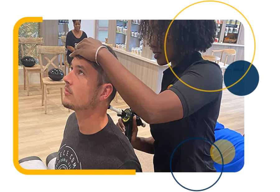 A man receives an ear examination from a healthcare professional in a modern clinic setting.