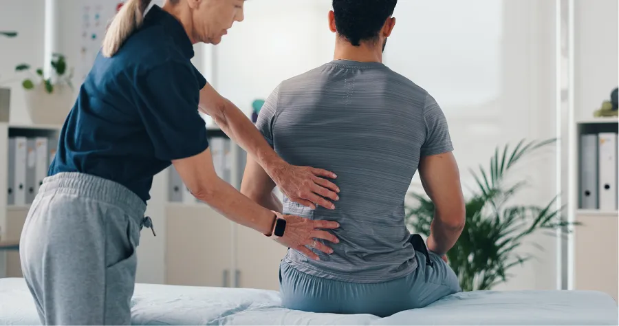 Hands giving a relaxing back massage on bare skin in a calm indoor setting.