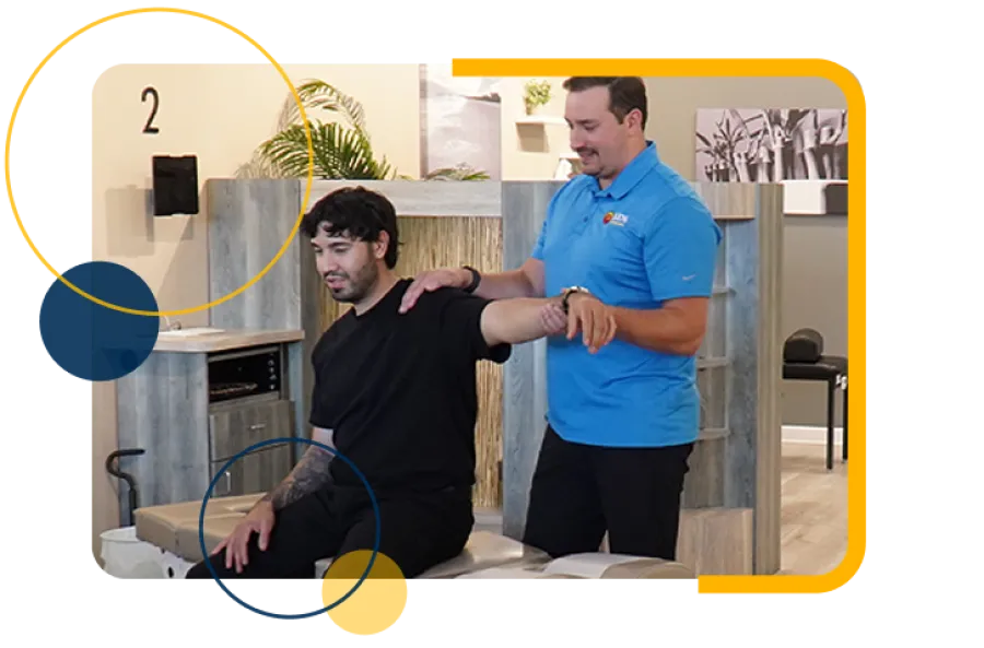 Chiropractor in blue shirt assisting male patient with arm stretch in modern clinic setting.