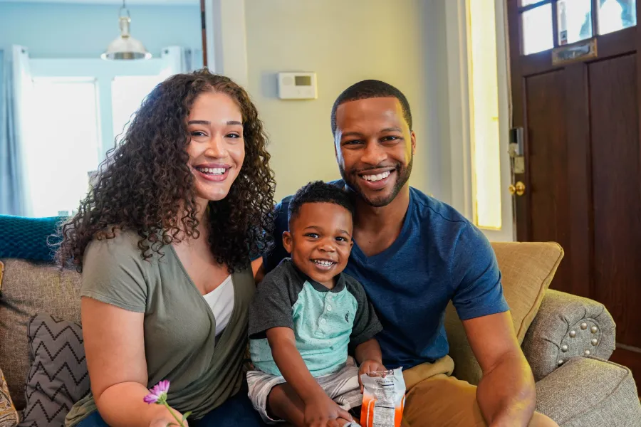 a family sitting on a couch