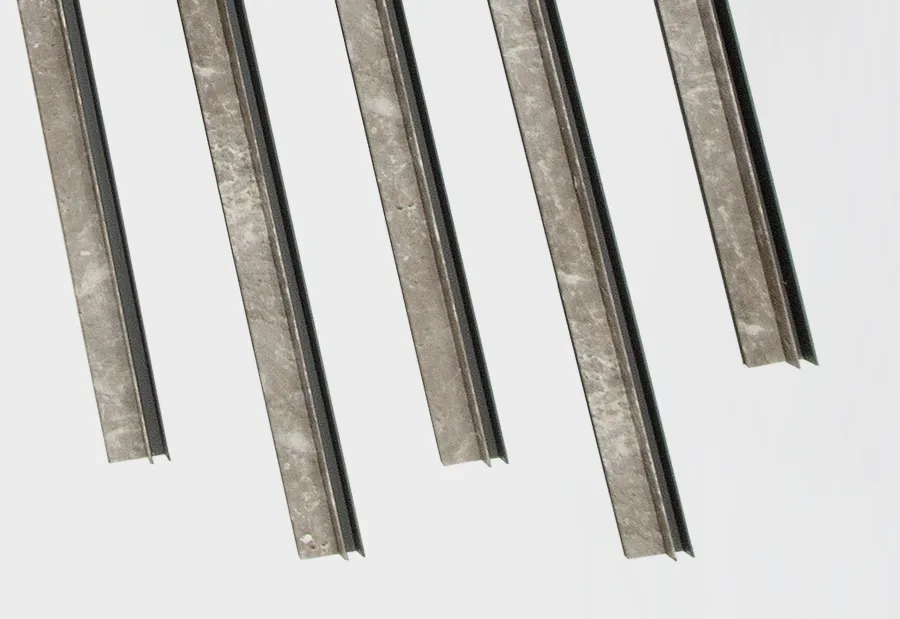 Several marble-styled inside corner trim pieces angles arranged vertically on a plain white background for construction use.