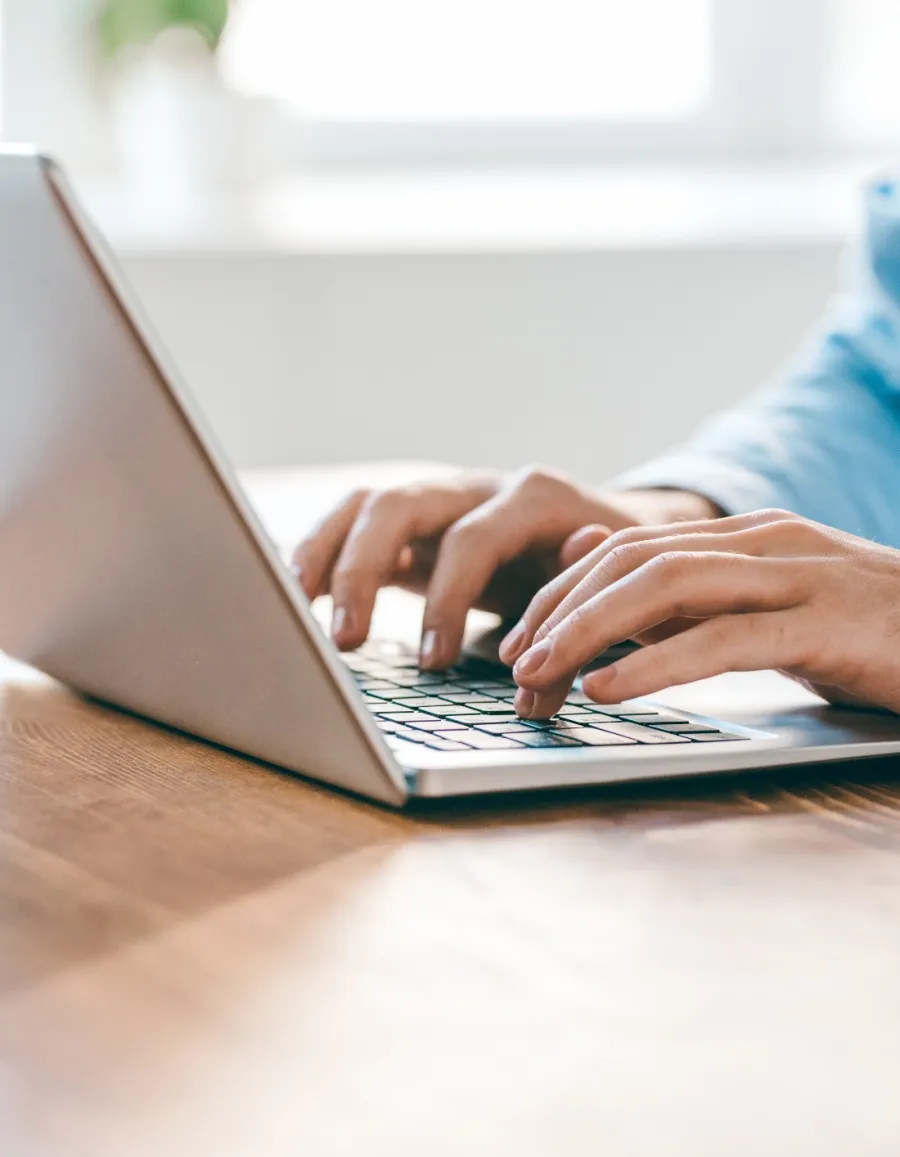 a person typing on a laptop