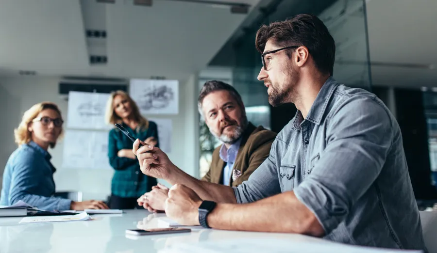 a group of people sitting at a table talking