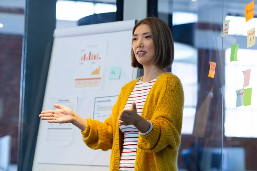 a person standing in front of a white board