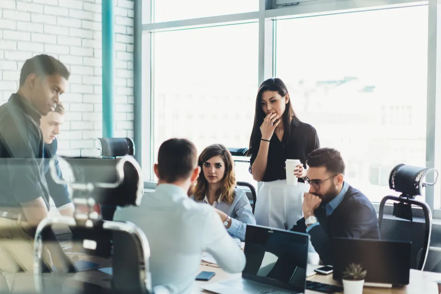 a group of people sitting in a meeting