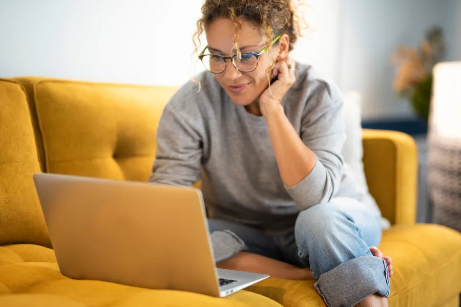 a man sitting on a couch with a laptop