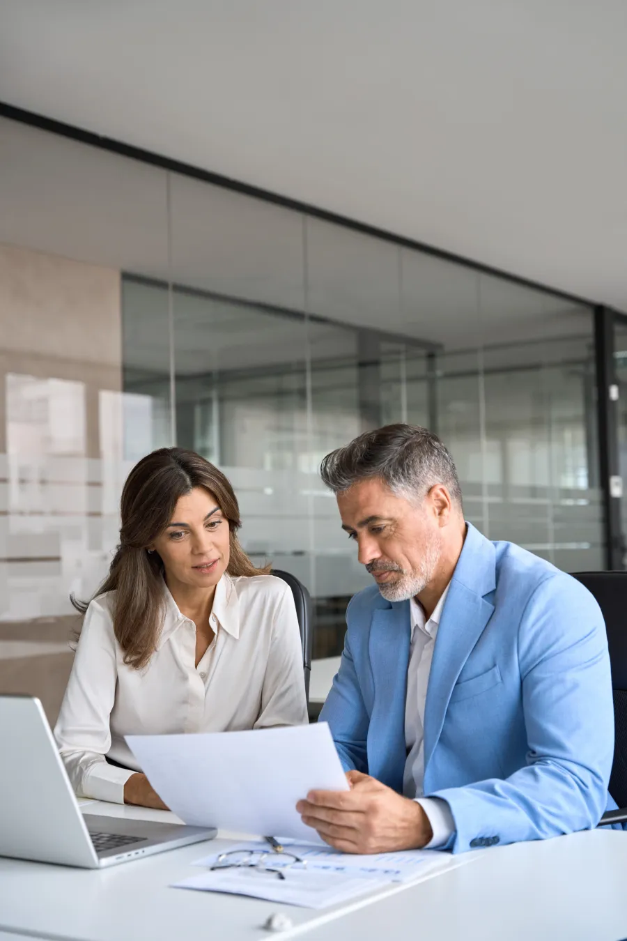 a man and a woman looking at a paper