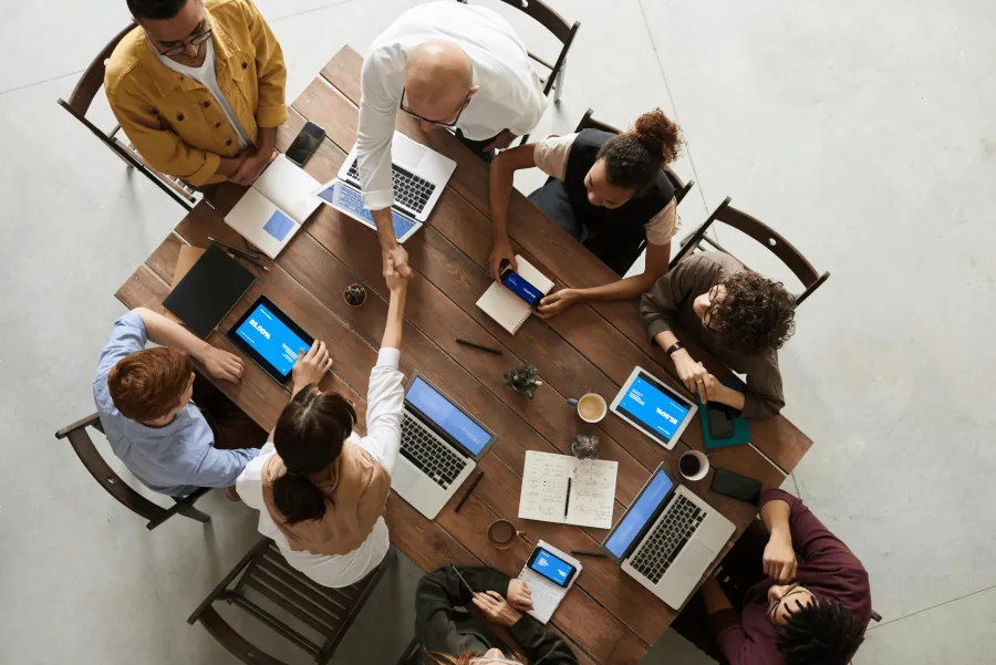 a group of people working on laptops