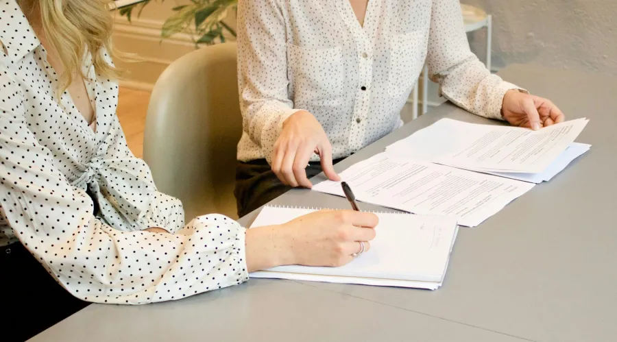 a woman signing a document