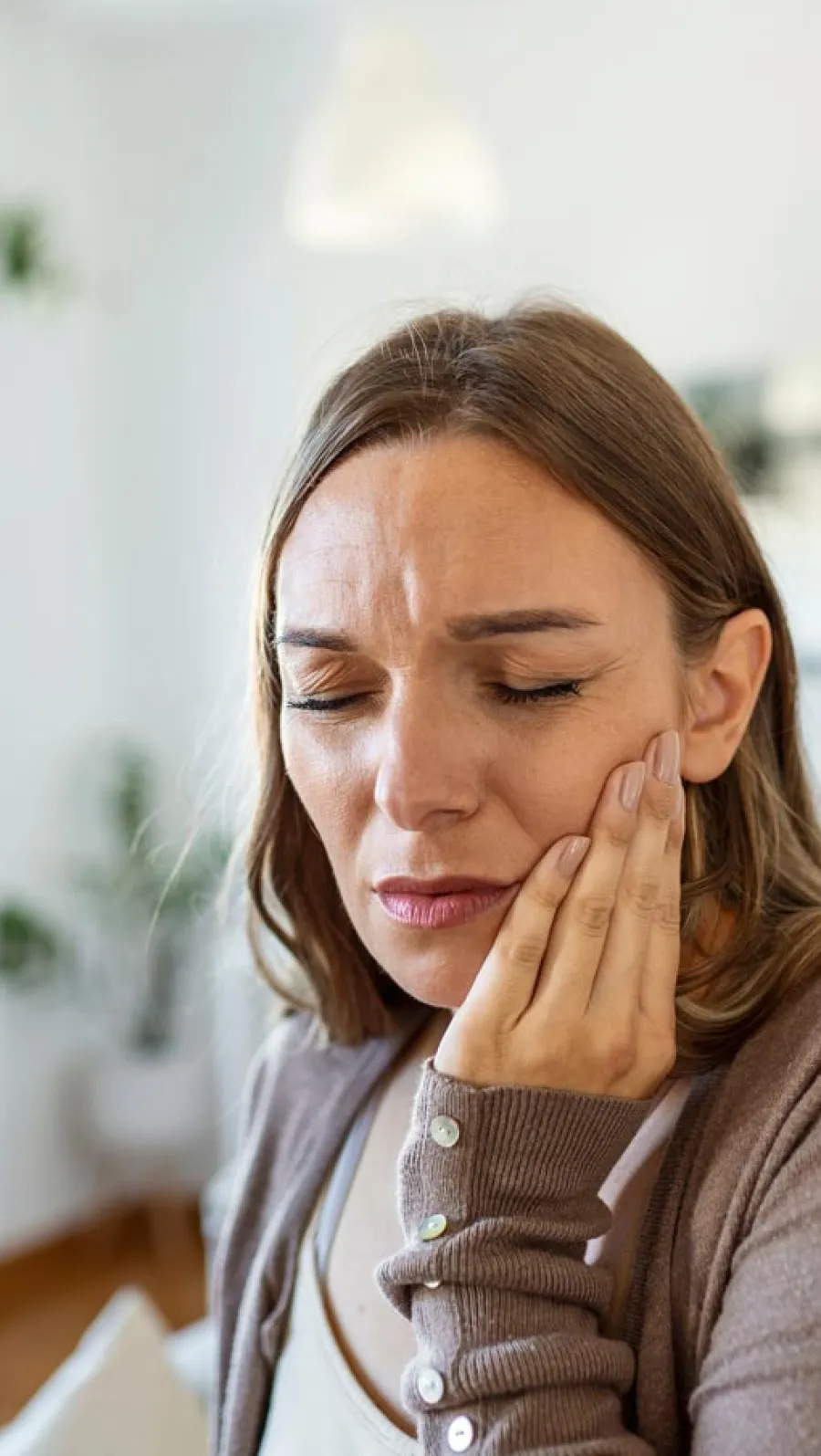 a woman with her hand on her face