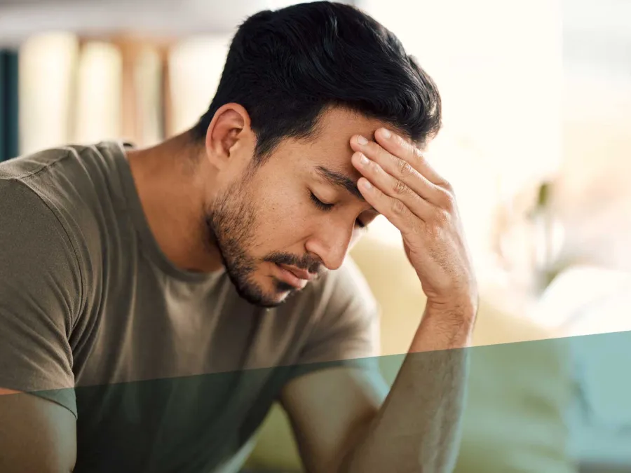 a man with his hand on his face