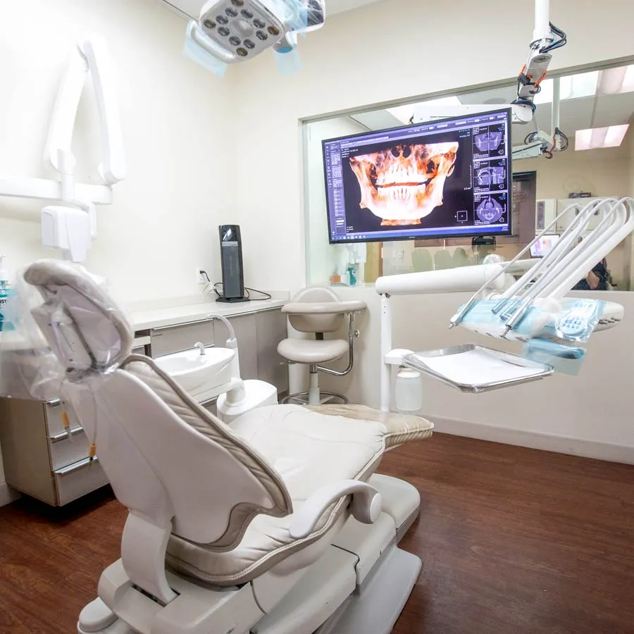 Modern dental office interior with high-tech equipment and a patient chair ready for use.