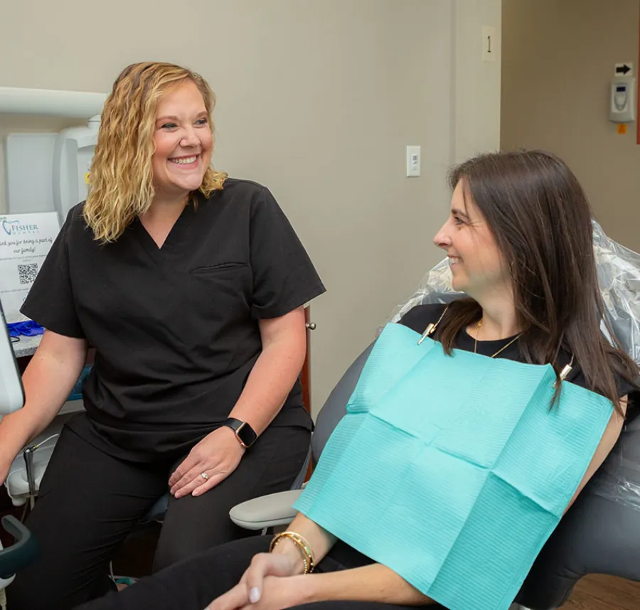 a woman sitting next to another woman