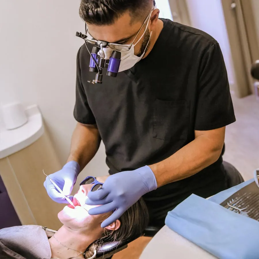 Smiling woman at dental appointment, feeling relaxed and happy in a modern clinic.