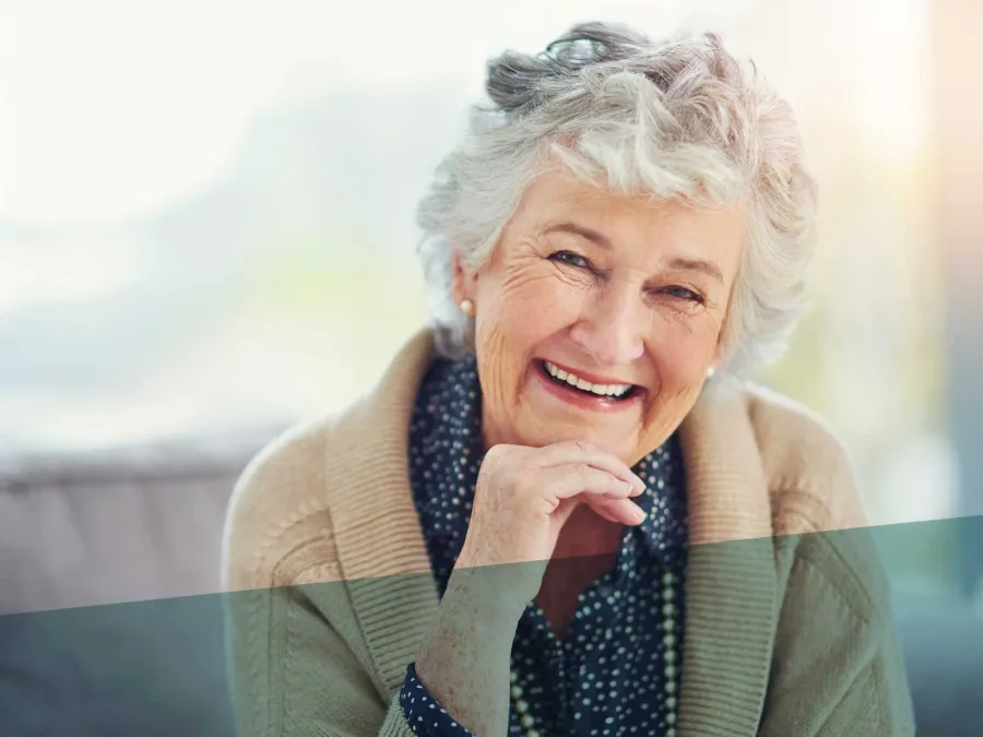 a person smiling with the hand on the chin