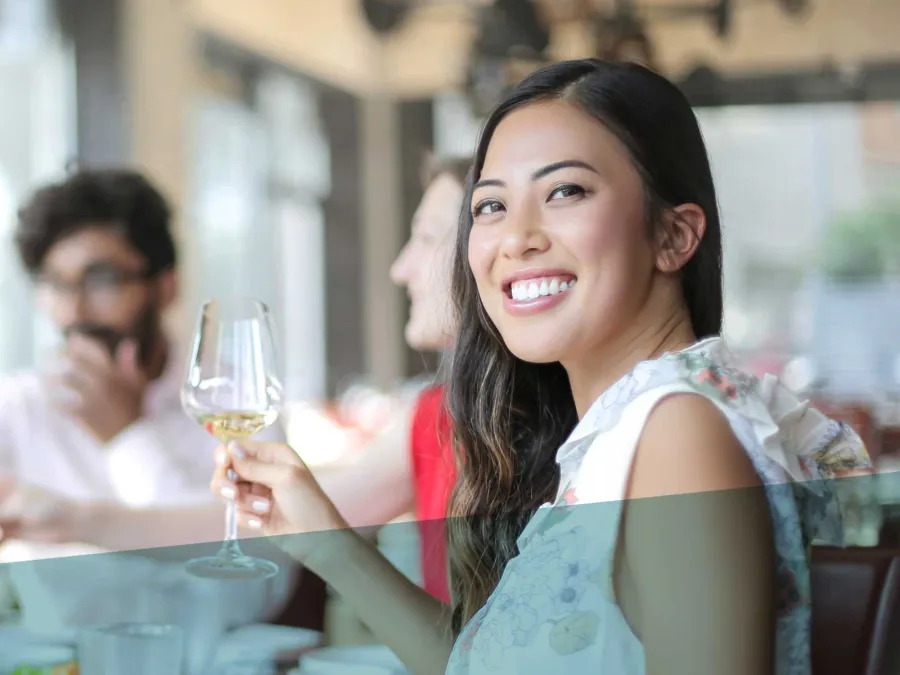 a woman holding a glass of wine
