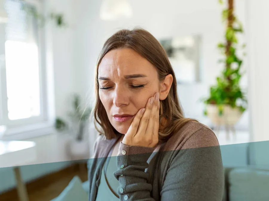 a woman with her hand on her face