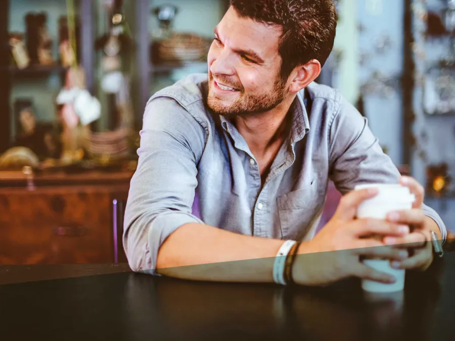 a man holding a cup