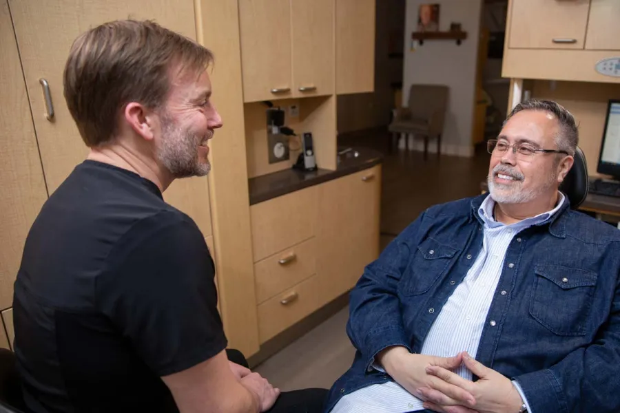 a man sitting next to another man
