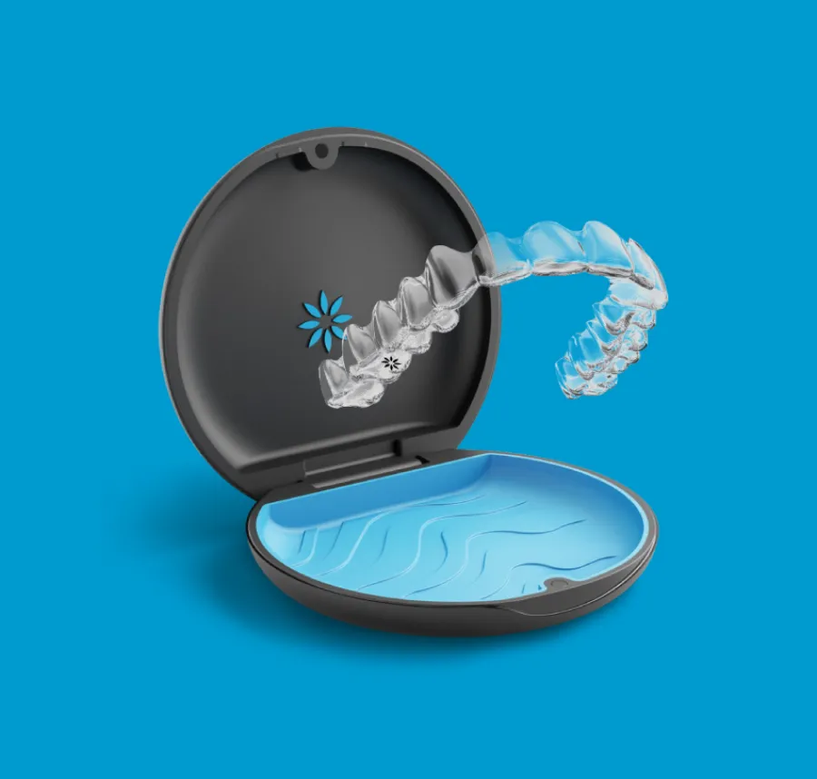 Transparent clear dental aligner floating above an open black and blue protective case on a blue background.