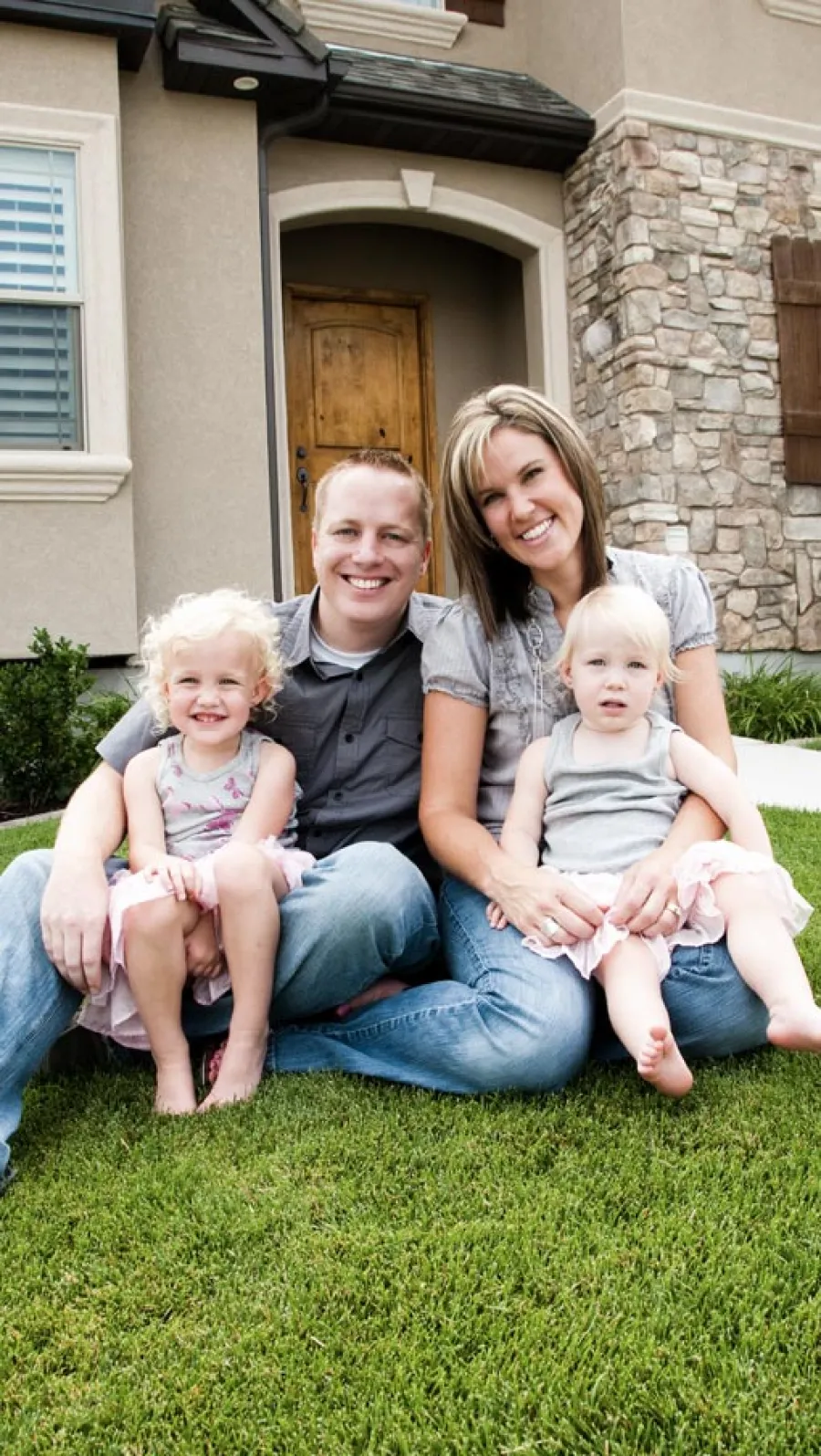 a family sitting on the grass