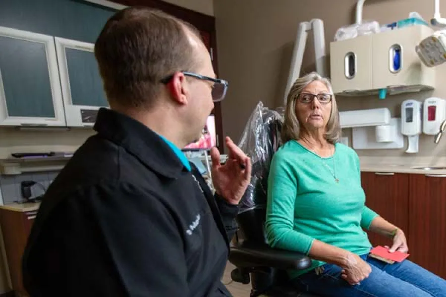 a man and a woman in a dental office