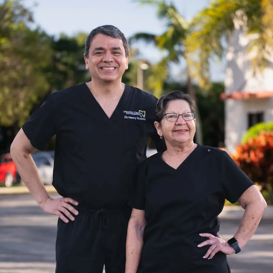 Exterior view of Shook Dental Care clinic with a large tooth logo on yellow building under clear sky