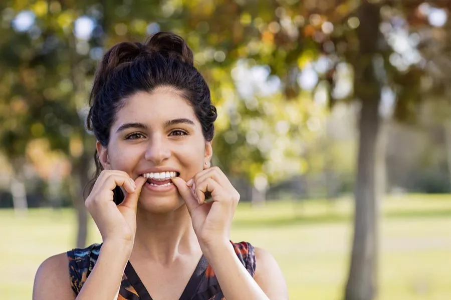 a person with the hands on the face