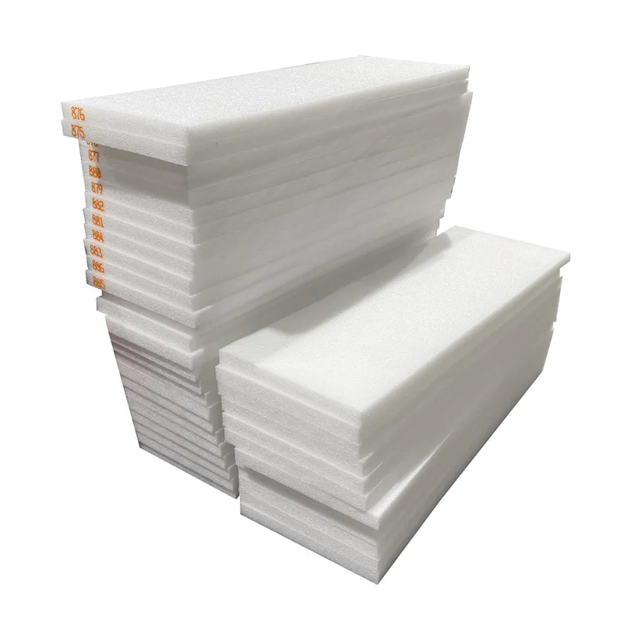Stacks of white foam sheets neatly arranged against a white background