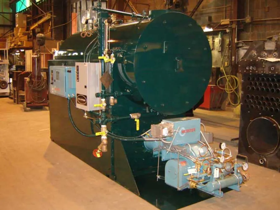 Industrial boiler system with control panel and gauges in a large factory setting.