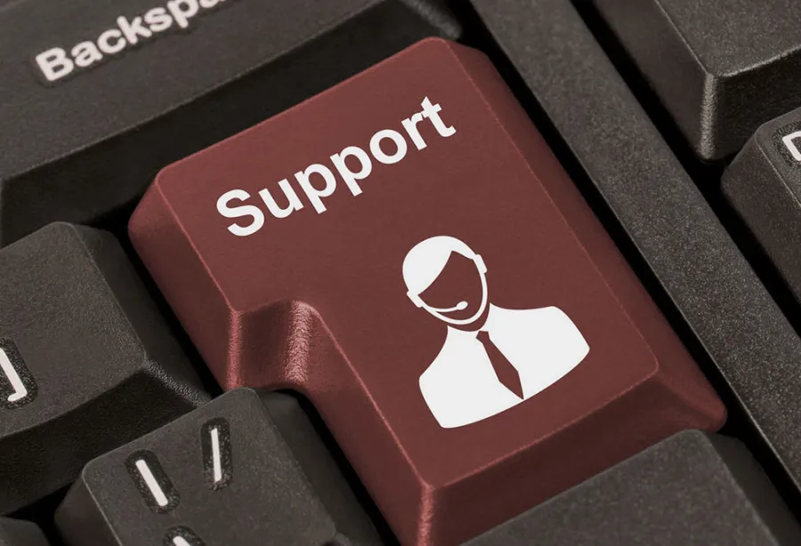 Close-up of a red keyboard key labeled Support with a headset-wearing customer service icon.