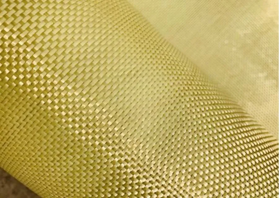 Close-up of yellow woven fabric with detailed texture and pattern, showing tightly interlaced fibers.