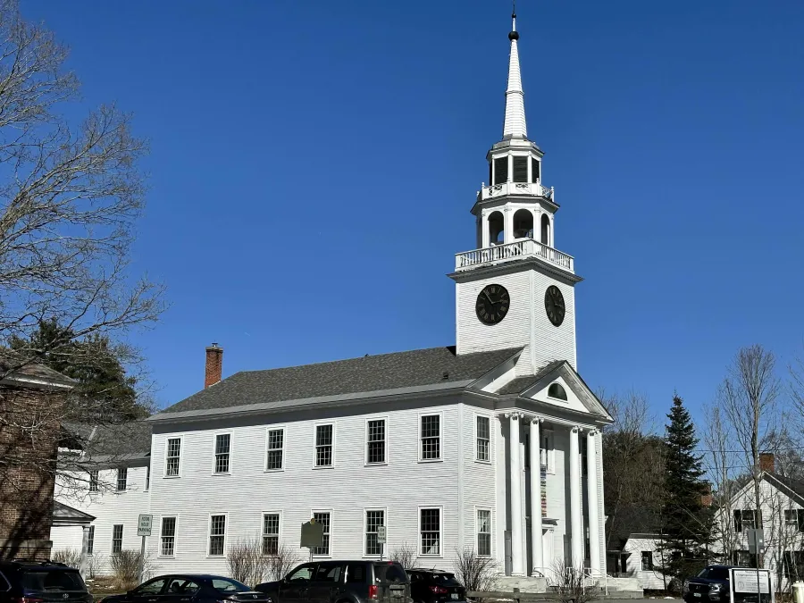 a white building with a clock tower