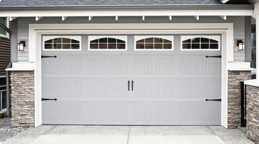 a garage door with a brick wall