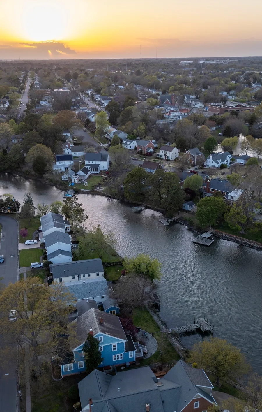 a river with houses and trees